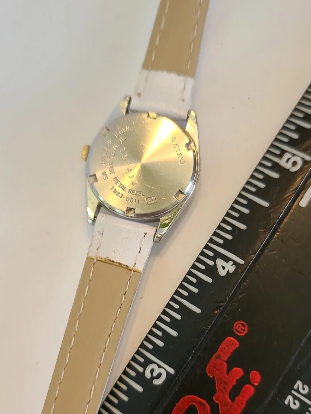 Seiko White Dial Watch with Gold Bezel and White Strap